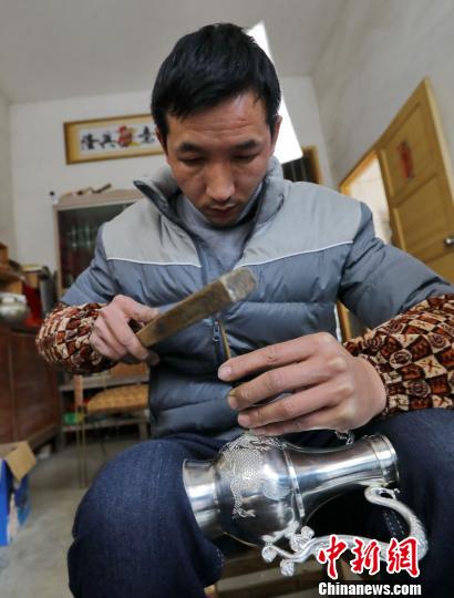 栩栩如生的麒麟圖案在錫壺上漸漸展現(xiàn)�！↑S水林 攝